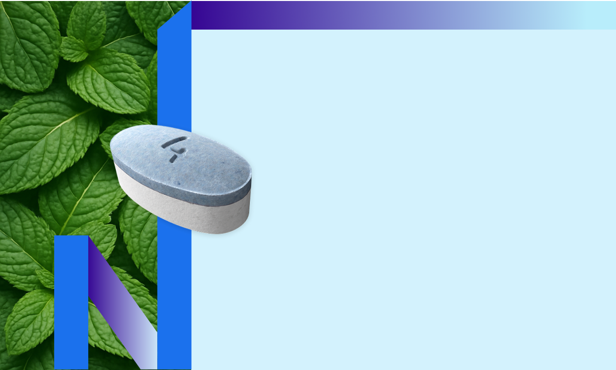 A mini lozenge tablet whit green leaf in the background