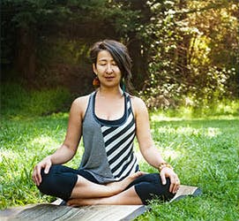 A woman relaxing with guided meditation.
