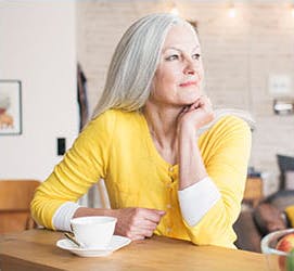 A woman enjoying a cup of tea.